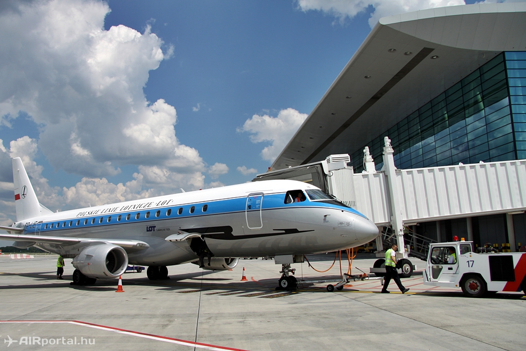 A LOT retro festésű Embraer E175 típusa a 39-es állóhelyen, háttérben a SkyCourt terminállal. (Fotó: Csemniczky Kristóf - AIRportal.hu) | © AIRportal.hu